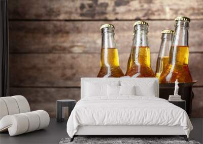 Cold bottles of beer in the bucket on the wooden background Wall mural