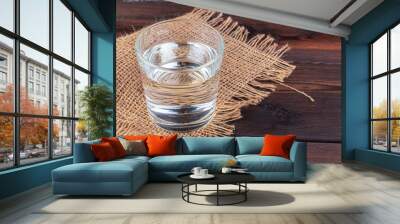 Glasses of water on a wooden table. Wall mural