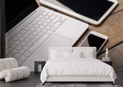 Open laptop with digital tablet and white smartphone close up top view Wall mural