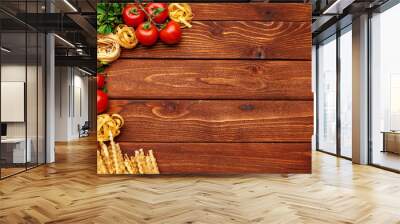 Pasta and ingredients on wooden background with copy space. Top view. Wall mural