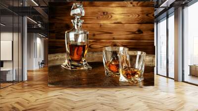 Two glasses of brandy or cognac and bottle on the wooden table Wall mural