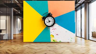 Vintage alarm clock on a creative colorful background with paint sprinkles Wall mural