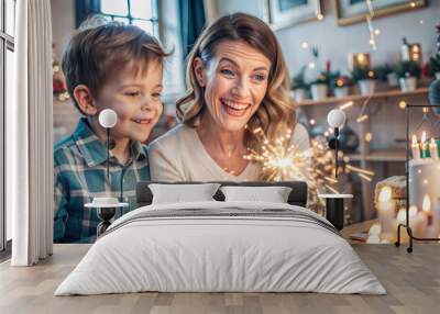 Grandmother and grandson with sparklers celebrating christmas together at home Wall mural