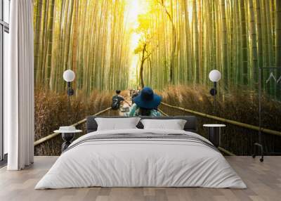 Tourist is cycling for sightseeing at Arashiyama bamboo forest in Kyoto, Japan. Wall mural