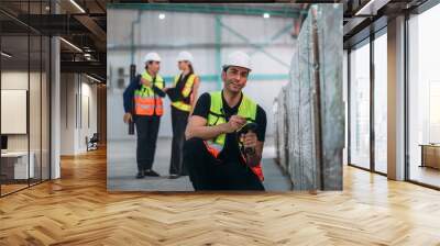 A man in a safety vest is standing in front of a wall of cardboard boxes Wall mural