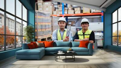 Portrait of a Happy warehouse worker in a warehouse or storehouse while looking at camera. Wall mural