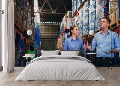 Warehouse worker working and checking the stock in the warehouse. .Factory manager using digital tablet check barcode in industry factory logistic. Wall mural