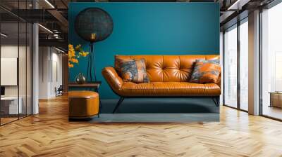 A patchwork orange and brown leather sofa is set against a turquoise blank wall with plenty of copy space in the minimalist home interior design of the modern living room Wall mural