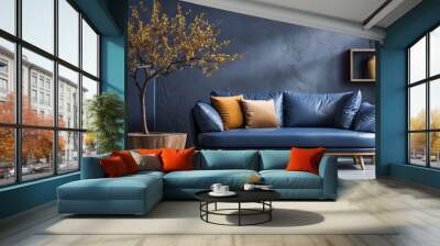 Loft home interior design of a modern living room with a dark blue sofa and round wooden coffee table against a concrete wall with painted tree branches Wall mural