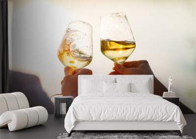 glasses with white wine splash in the hands Wall mural