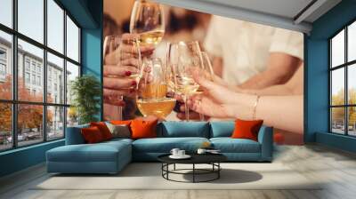 Celebration. Hands holding the glasses of champagne and wine making a toast. Wall mural