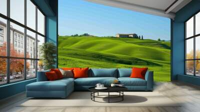 Rolling green hills with a lone farmhouse under a clear blue sky Wall mural