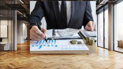 Businessman accountant counting money and making notes at report doing finances and calculate about cost of investment and analyzing financial data, Financing Accounting Banking Concept Wall mural