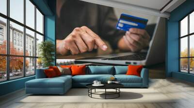 Businessman holding credit card and typing on laptop for online shopping and payment makes a purchase on the Internet, Online payment, Business financial and technology Wall mural