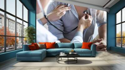 Doctor using a stethoscope checking patient with examining, presenting results symptom and recommend treatment method, Healthcare and medical concept Wall mural