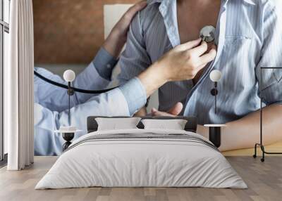 Doctor using a stethoscope checking patient with examining diagnosis Wall mural