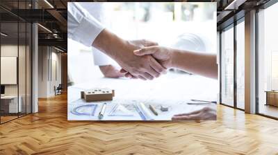 Handshake of collaboration, Construction engineering or architect discuss a blueprint and building model while checking information on sketching, meeting for architectural project of partner Wall mural