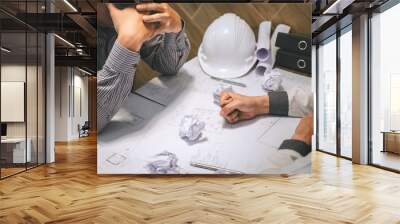 Team of construction engineering or architect partner discuss a blueprint while checking information on drawing and sketching meeting for architectural project with engineering equipment tool Wall mural