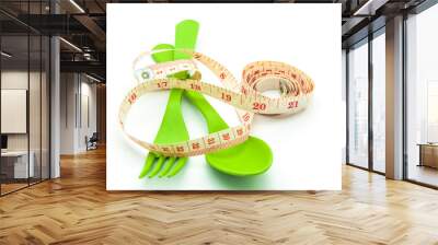 Green spoon and fork with measuring tape isolated on white backg Wall mural