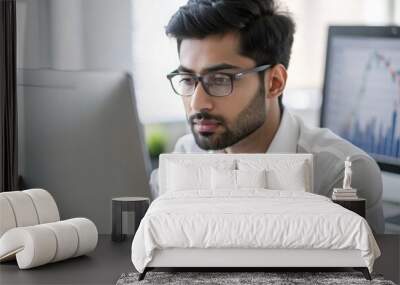 An Indian financial analyst working diligently at a workstation.
 Wall mural