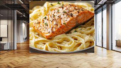 A plate of pasta with a piece of salmon on top. The salmon is seasoned with herbs and spices. The pasta is cooked and served in a bowl Wall mural