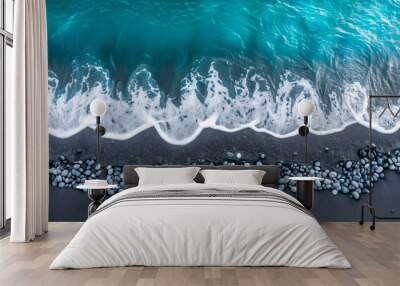 Aerial drone view or top view perspective photography of a beautiful transparent clear sea or ocean waves and foam splashing on the dark navy blue sand beach  Wall mural