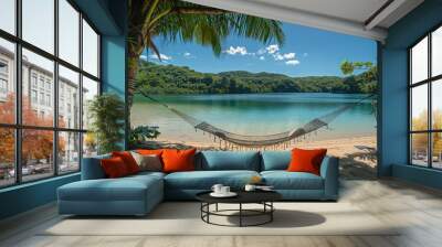 Secluded beach with a hammock strung between two palm trees, overlooking a turquoise lagoon Wall mural