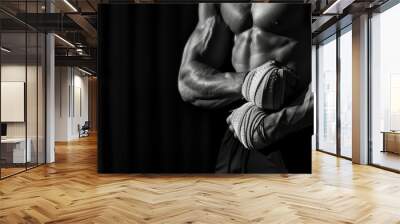 Bodybuilder fitness lifestyle concept Croped black and white shot on black background Man is wrapping hands with boxing wraps isolated Strong hands and fist - generative ai Wall mural