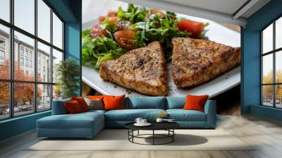 Close Up Still Life of Two Fried Tuna Steaks on Square White Plate with Seasoning and Fresh Green Salad with Tomato on Painted Wooden Table - generative ai Wall mural