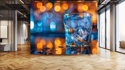 Gorgeous view of transparent old-fashioned glass with ice cubes standing on bar counter on blurred background - generative ai Wall mural