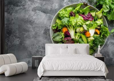 Green vegan salad from green leaves mix and vegetables. Top view on gray stone table. - generative ai Wall mural