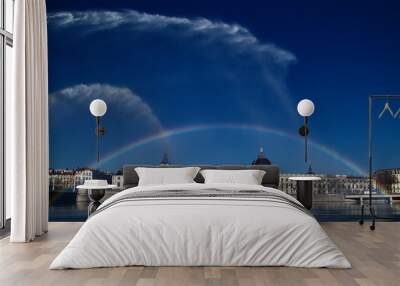 Panoramic photo of the Grand Hotel-Dieu surmounted by a magnificent rainbow created by jets of water that firefighters operate. It’s in Lyon, France, at sunrise. Wall mural