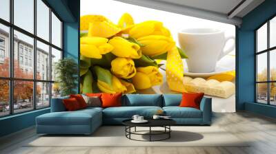 bouquet of yellow tulips with a cup of coffee and a slice of whi Wall mural