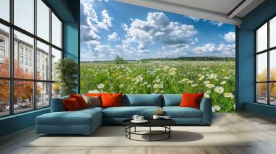 Beautiful summer colorful panoramic landscape of flower meadow with daisies against blue sky with clouds. Wall mural