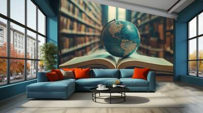 Large-scale data Earth globe resting on top of an open book in the background, illustrating an educational concept with a textbook or opening book in an old libraryE-learning idea Wall mural