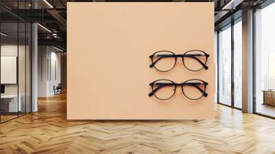 Minimalist summer fashion: 2 eyeglass pairs on beige. Trendy still life for optic store sale Wall mural