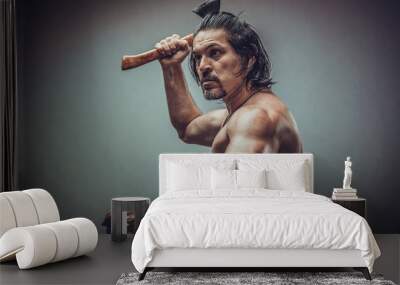 sexy muscular body model portrait of a young man holding an ax in his hands Wall mural