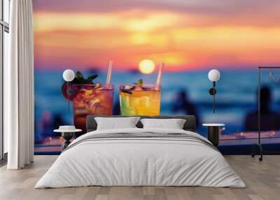 Two cocktails against a blurred beach party backdrop with colorful sunset sky. Luxury outdoor leisure, relaxed and romantic ambiance, people mingling on a summer evening Wall mural