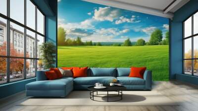 Beautiful blurred background image of spring nature with a neatly trimmed lawn surrounded by trees against a blue sky with clouds on a bright sunny day. Wall mural