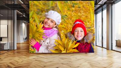 two little girls in autumn park with leafs Wall mural