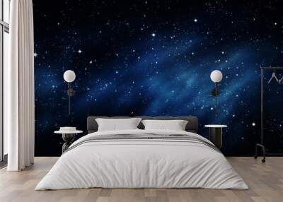 A star-filled night sky with blue nebulous clouds creating a stunning cosmic scene. The stars sparkle brightly against the deep blue background, evoking wonder. Wall mural