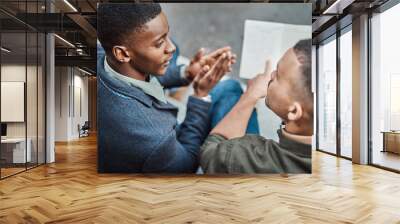 Constructing the perfect recipe for success. Shot of two young businessmen having an informal meeting against an urban background. Wall mural