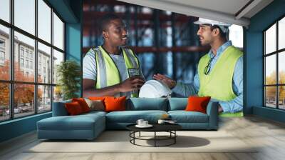 I dont want any problems. Shot of two young contractors standing in the warehouse together and having a discussion. Wall mural