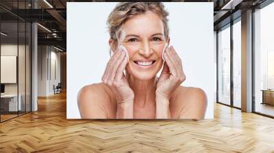 I have some tips thatll help take the years off. Shot of a mature woman holding cotton pads against her face. Wall mural