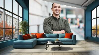 Business man standing with arms crossed, looking confident and proud in the city alone. Portrait of a black male entrepreneur or worker showing vision, ambition and success with arms folded downtown Wall mural