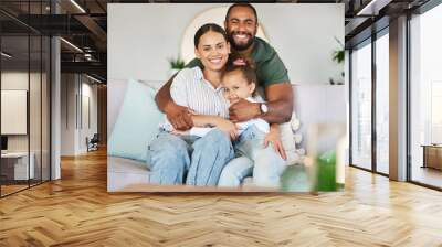 Cuddling up to a carefree day. Portrait of a happy family relaxing together at home. Wall mural