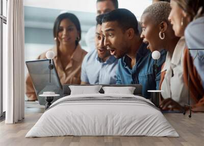 Dont be surprised when your dreams are finally realised. Shot of a group of young businesspeople using a laptop and looking shocked in a modern office. Wall mural