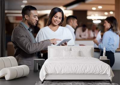 Every collaboration contributes to the bigger picture. Shot of a young businessman and businesswoman using a digital tablet at a conference. Wall mural