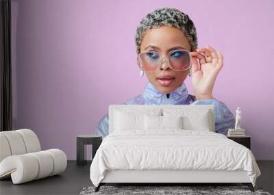 Fashion, beauty and mockup with a black woman in glasses on a pink background in studio for advertising and marketing. Style, edgy and trendy with an attractive female posing with cool sunglasses Wall mural