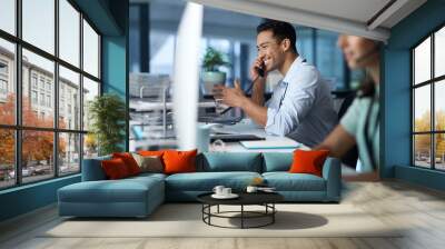 Good business is based on good communication. Shot of a young man answering the phone while working in a modern call centre. Wall mural